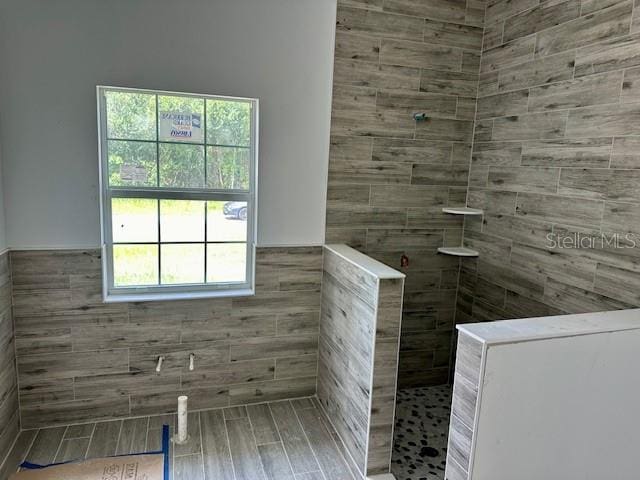 bathroom with a tile shower