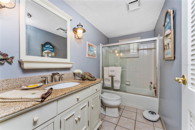 full bathroom featuring vanity, tile patterned floors, toilet, enclosed tub / shower combo, and a textured ceiling