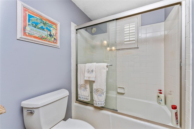 bathroom featuring toilet, enclosed tub / shower combo, and a textured ceiling