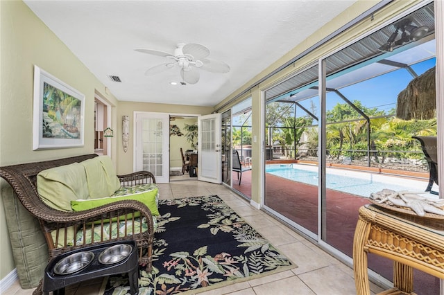 sunroom featuring ceiling fan