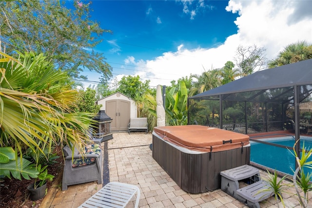 view of patio / terrace with a shed, glass enclosure, and a hot tub