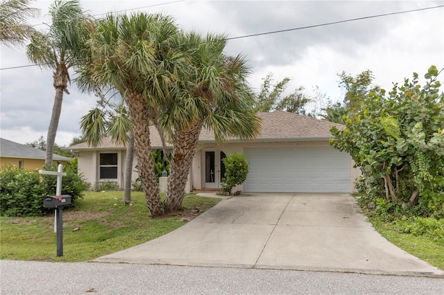 view of front of home with a front lawn and a garage