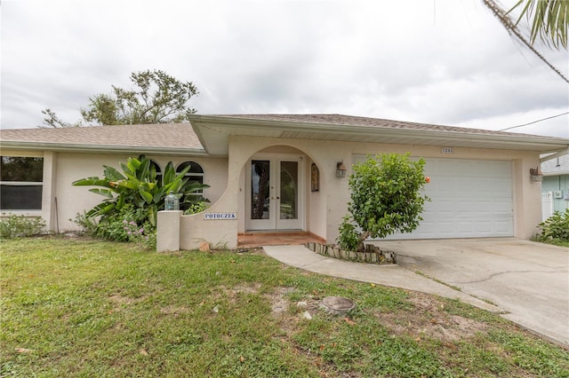 mediterranean / spanish house with a front lawn and a garage