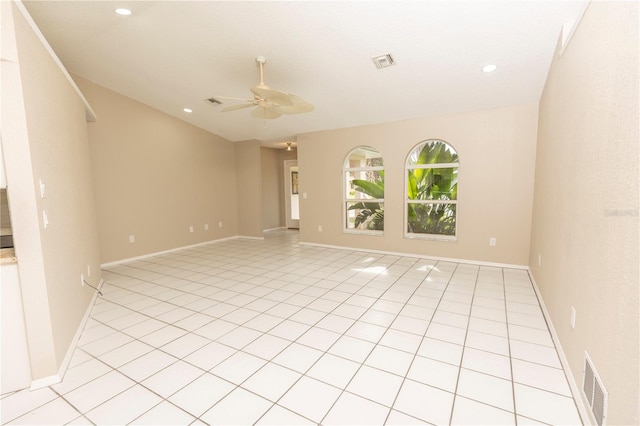 tiled spare room with vaulted ceiling and ceiling fan