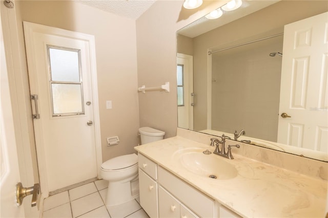 bathroom featuring tile floors, toilet, a textured ceiling, and vanity