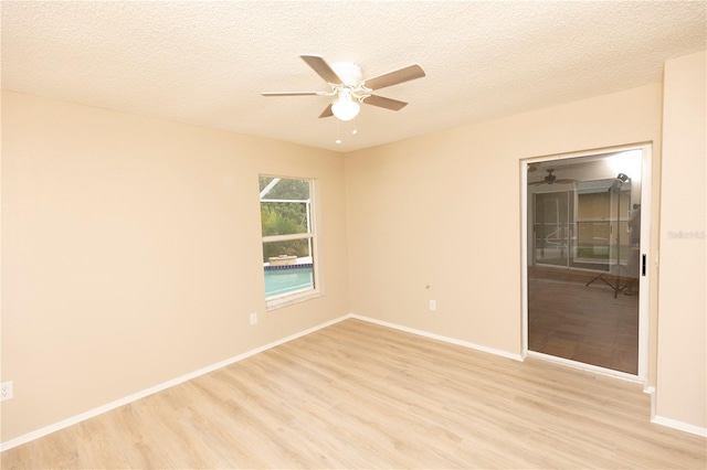 unfurnished room with a textured ceiling, ceiling fan, and light hardwood / wood-style flooring