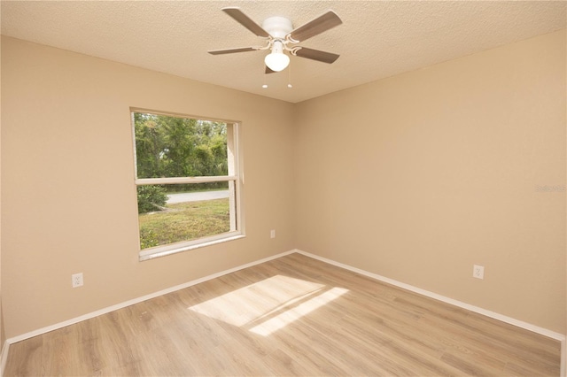 spare room with plenty of natural light, light hardwood / wood-style floors, a textured ceiling, and ceiling fan