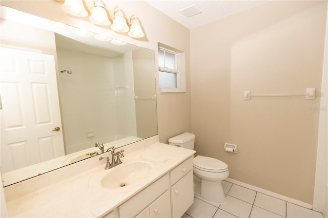 bathroom with vanity, tile flooring, a textured ceiling, and toilet