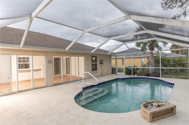 view of pool featuring a patio area and glass enclosure