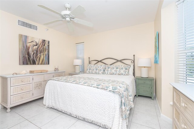 bedroom with light tile floors and ceiling fan