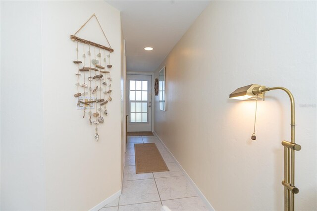 hall featuring light tile floors