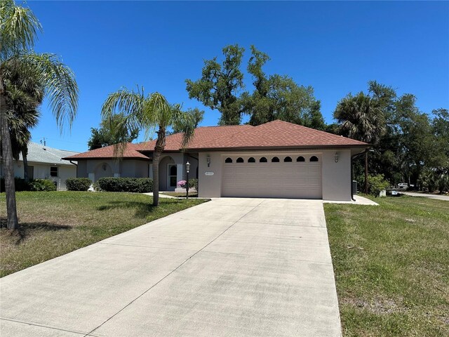 single story home featuring a garage and a front lawn