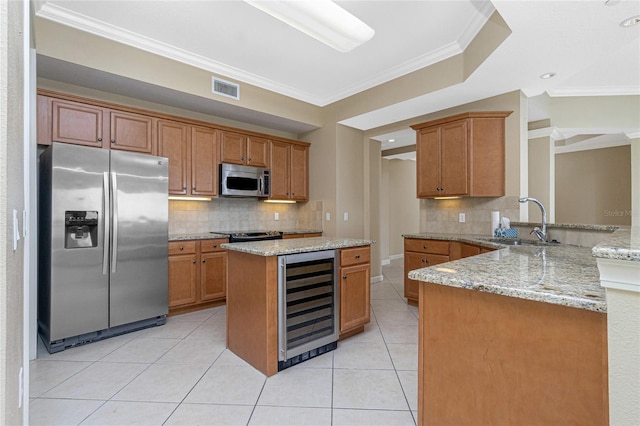 kitchen featuring appliances with stainless steel finishes, crown molding, tasteful backsplash, and beverage cooler