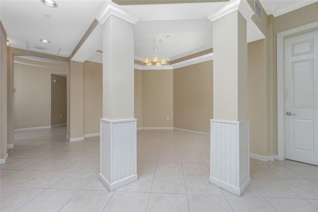 tiled spare room with a notable chandelier, ornate columns, and crown molding