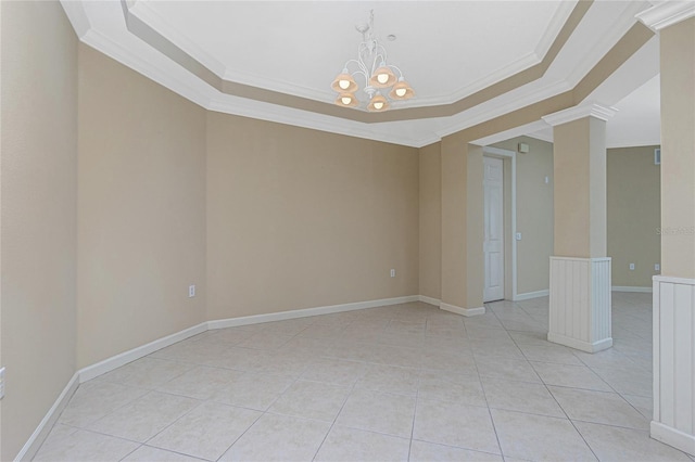 empty room featuring a raised ceiling, a notable chandelier, and light tile floors