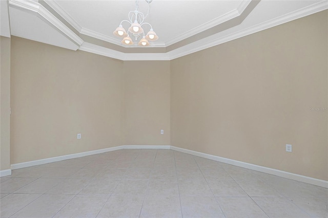 unfurnished room with a chandelier, a tray ceiling, light tile flooring, and ornamental molding