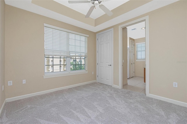 carpeted spare room with ceiling fan