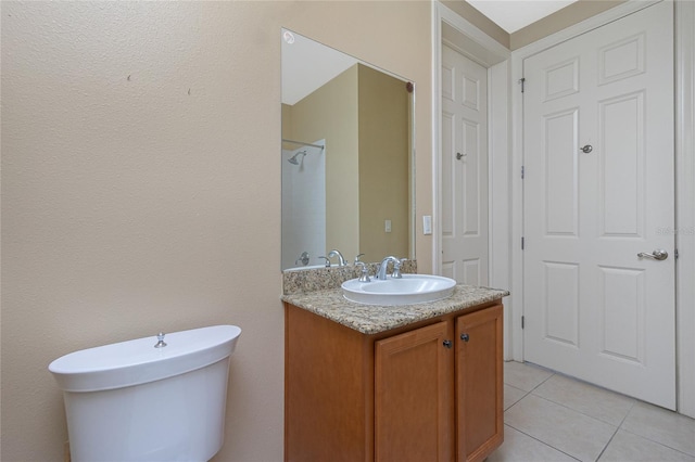 bathroom featuring vanity, tile flooring, and toilet