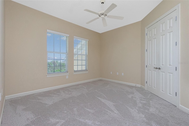 empty room with light carpet and ceiling fan