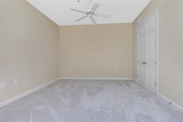 empty room featuring light carpet and ceiling fan