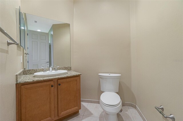 bathroom with toilet, tile floors, and large vanity