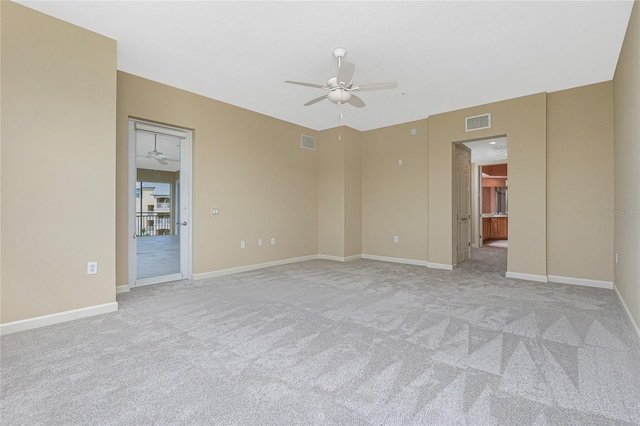 carpeted spare room with ceiling fan