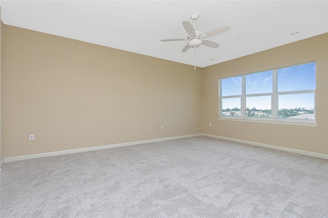 unfurnished room featuring light carpet and ceiling fan