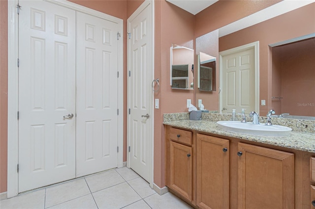 bathroom with tile flooring and large vanity