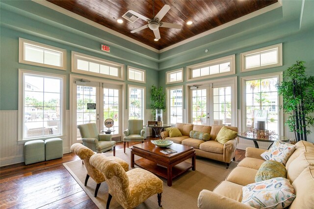 living room with ceiling fan, wood ceiling, crown molding, french doors, and hardwood / wood-style flooring