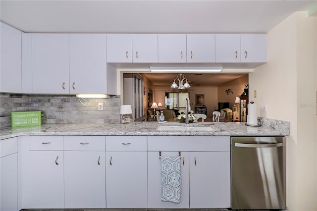 kitchen with white cabinets, stainless steel dishwasher, hanging light fixtures, and sink