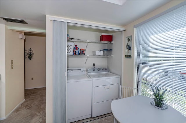 laundry area with light tile flooring, electric dryer hookup, and washer and clothes dryer