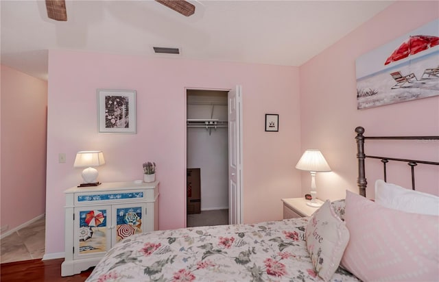 bedroom with a closet, ceiling fan, and tile flooring