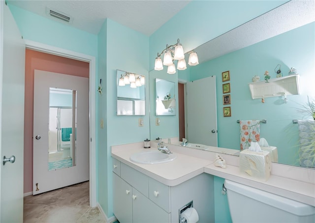 bathroom featuring oversized vanity, toilet, a textured ceiling, and tile floors