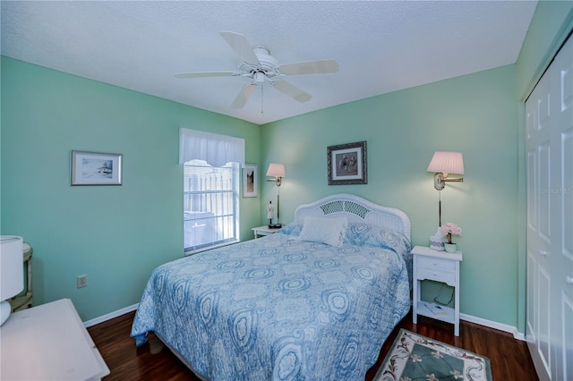 bedroom featuring ceiling fan, a closet, and dark wood-type flooring