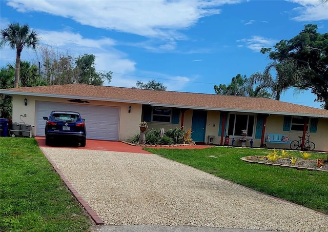 ranch-style house featuring concrete driveway, a front lawn, a garage, and stucco siding