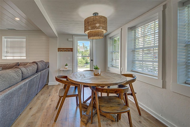 dining space with light hardwood / wood-style floors