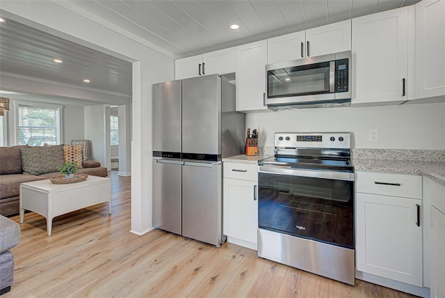 kitchen featuring light stone counters, crown molding, light hardwood / wood-style floors, stainless steel appliances, and white cabinetry