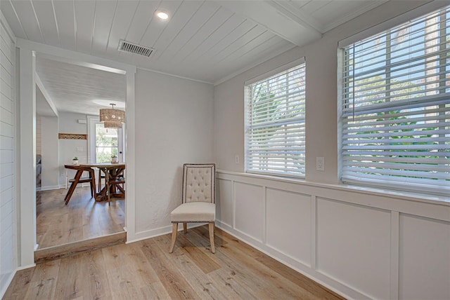 sitting room featuring crown molding and light hardwood / wood-style floors