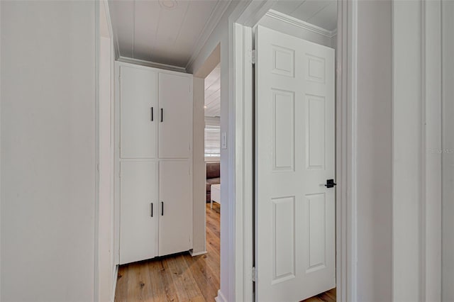 corridor featuring crown molding and light wood-type flooring