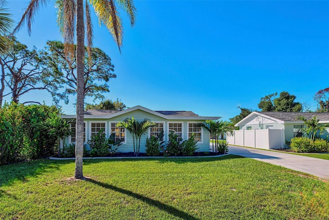 ranch-style home with a front lawn