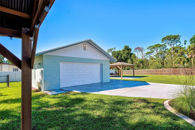 exterior space featuring a patio area, a garage, and a yard