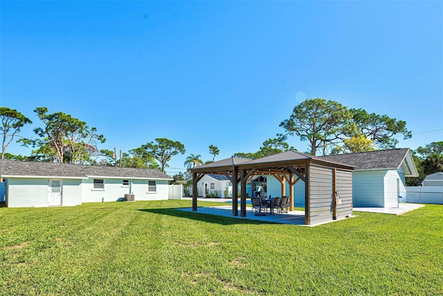 view of yard with a gazebo, central air condition unit, and an outdoor structure