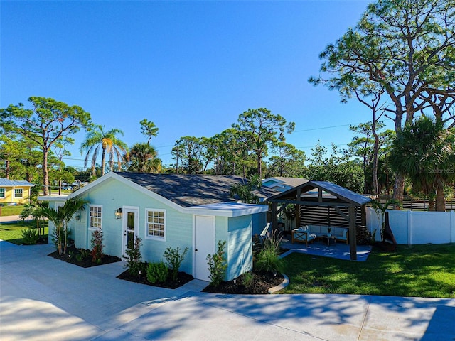 view of front of property with a gazebo and a front lawn