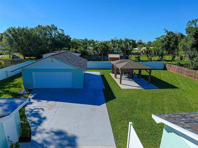 view of front facade featuring a gazebo, a front yard, and a garage