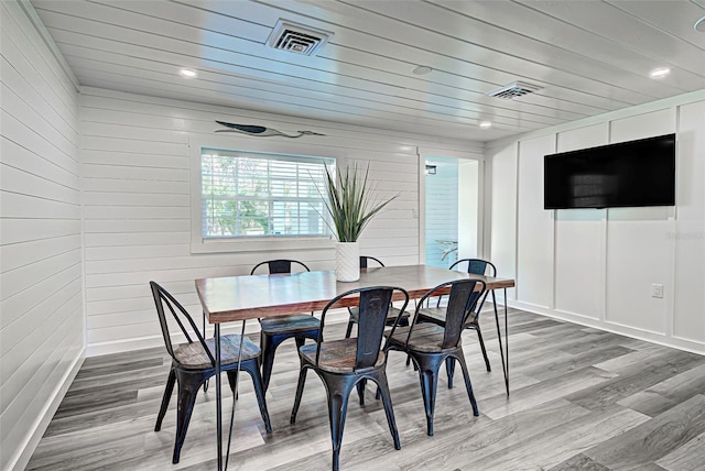 dining space with hardwood / wood-style flooring