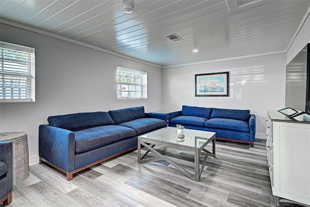 living room featuring ornamental molding and light hardwood / wood-style flooring