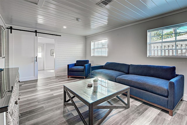 living room featuring a barn door, wood ceiling, and light hardwood / wood-style floors