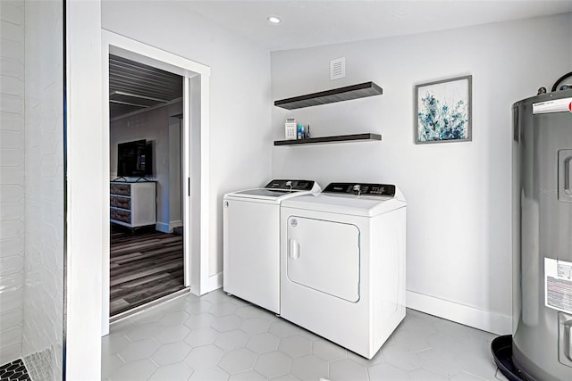 laundry room featuring light tile floors, electric water heater, and washing machine and dryer