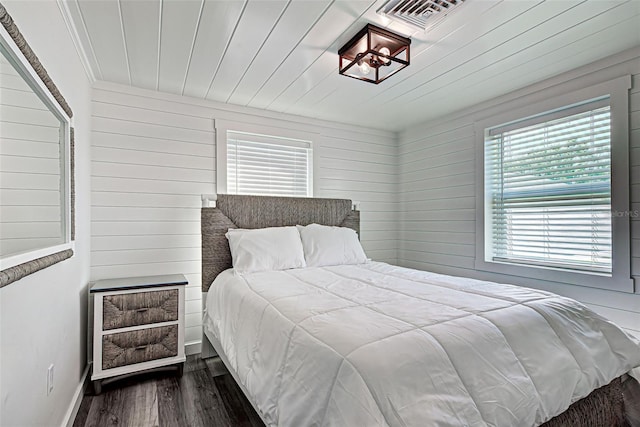 bedroom with dark hardwood / wood-style flooring