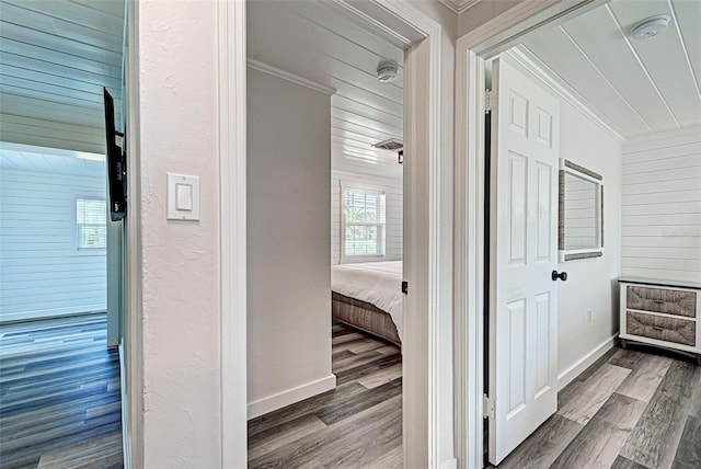 hall with ornamental molding and dark hardwood / wood-style floors